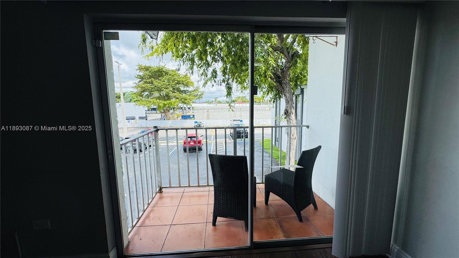 7226 Southwest 94th Place, Unit F7 Miami, FL 33173 - Photo 16 of 23 a view of a balcony with chairs and wooden floor
