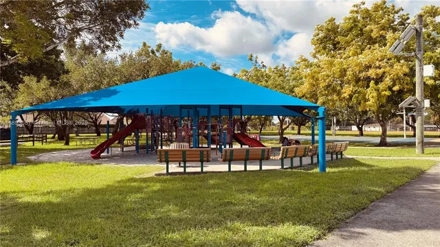 a view of a house with garden and sitting area