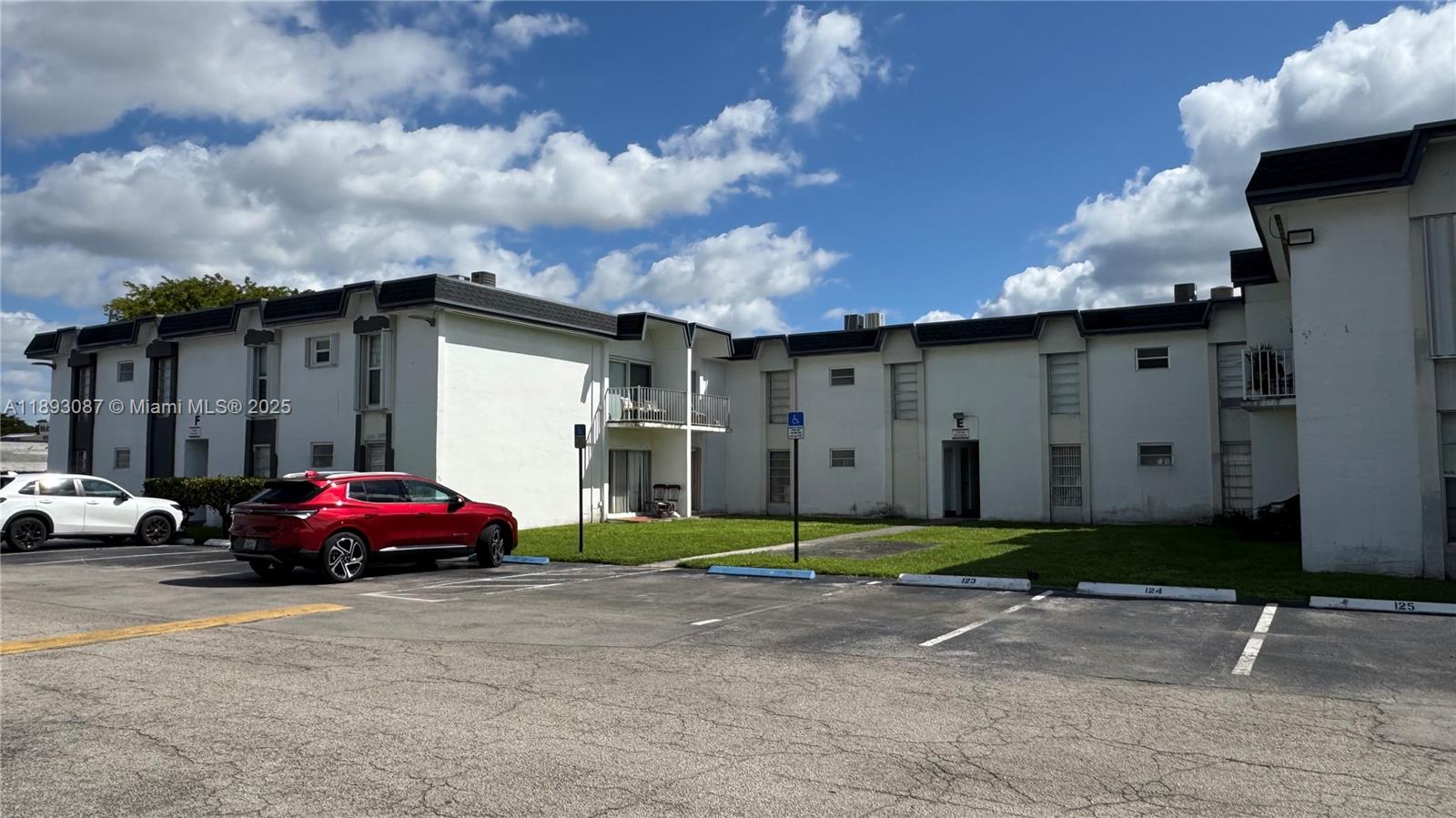7226 Southwest 94th Place, Unit F7 Miami, FL 33173 - Photo 22 of 23 a car parked in front of a house