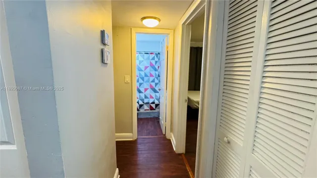 a view of a hallway with wooden floor
