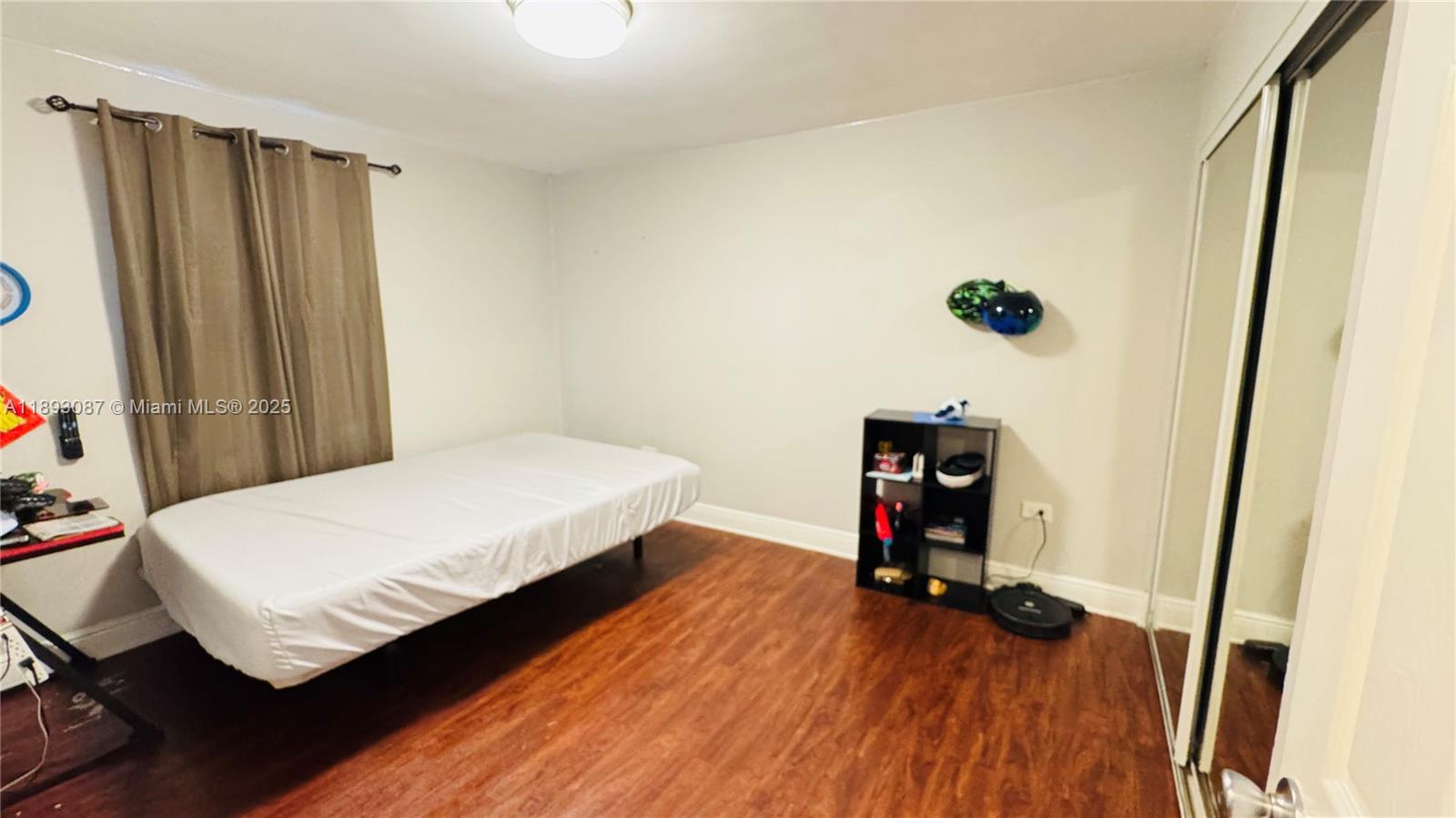 7226 Southwest 94th Place, Unit F7 Miami, FL 33173 - Photo 9 of 23 a bedroom with a bed and a flat tv screen on a dresser