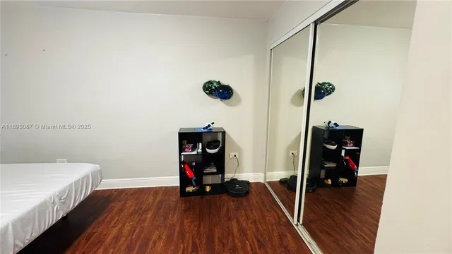 a view of a room with wooden floor and fan