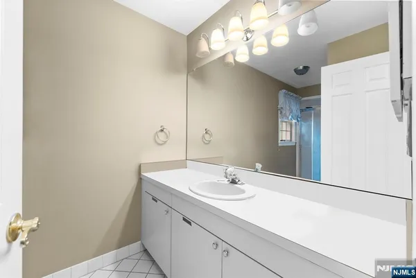 a bathroom with a sink vanity and a mirror