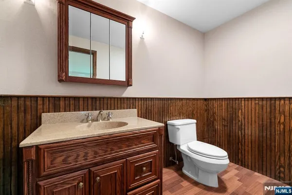 a bathroom with a sink a toilet and mirror