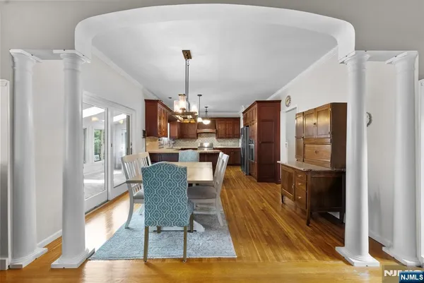 a view of a dining room with furniture wooden floor and kitchen view