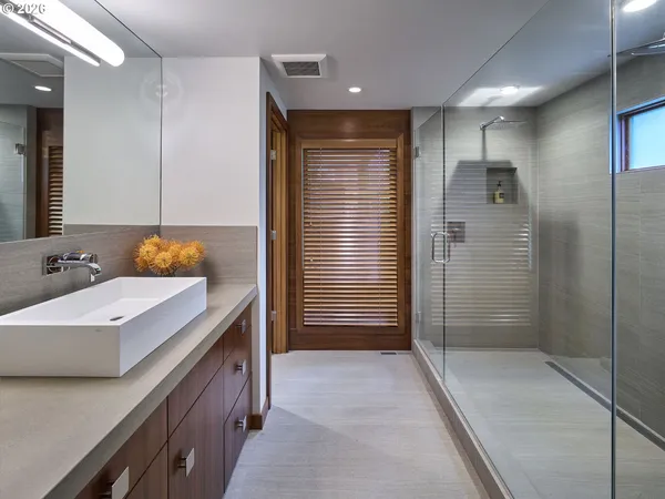 a bathroom with a glass shower door