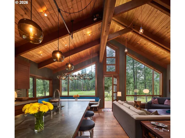 a living room with furniture a floor to ceiling window and flat screen tv