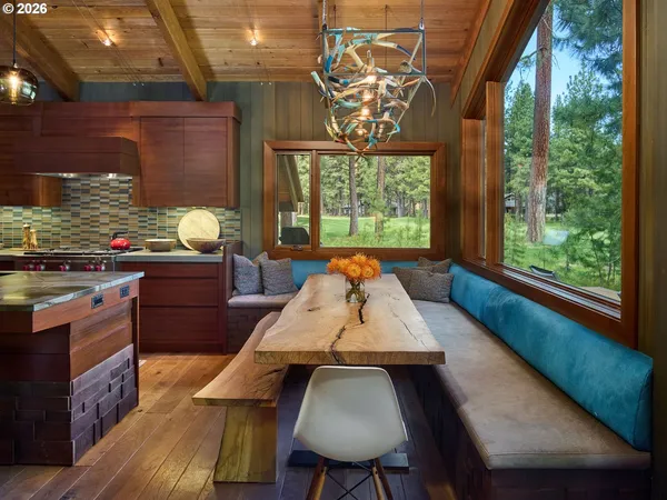 a view of a dining room with furniture a chandelier and wooden floor