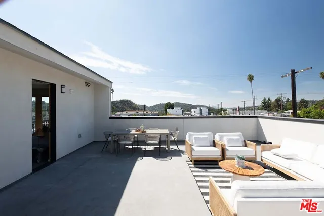 a terrace with outdoor seating and city view