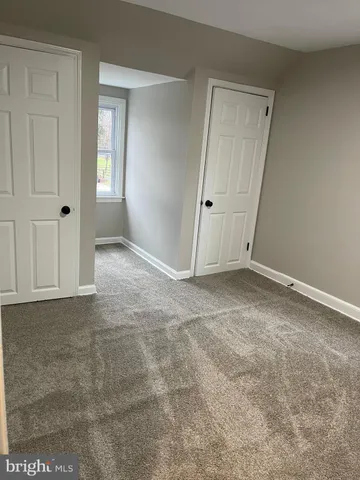 a view of a hallway to rooms