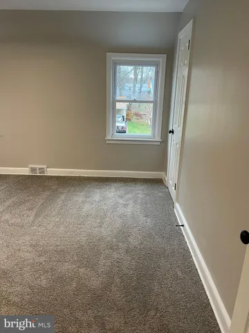 a view of an empty room and a window