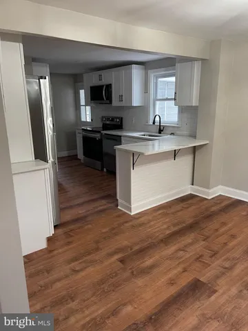 a kitchen with stainless steel appliances granite countertop a refrigerator sink and microwave