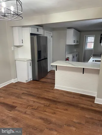 a view of kitchen with stainless steel appliances a refrigerator and a stove top oven