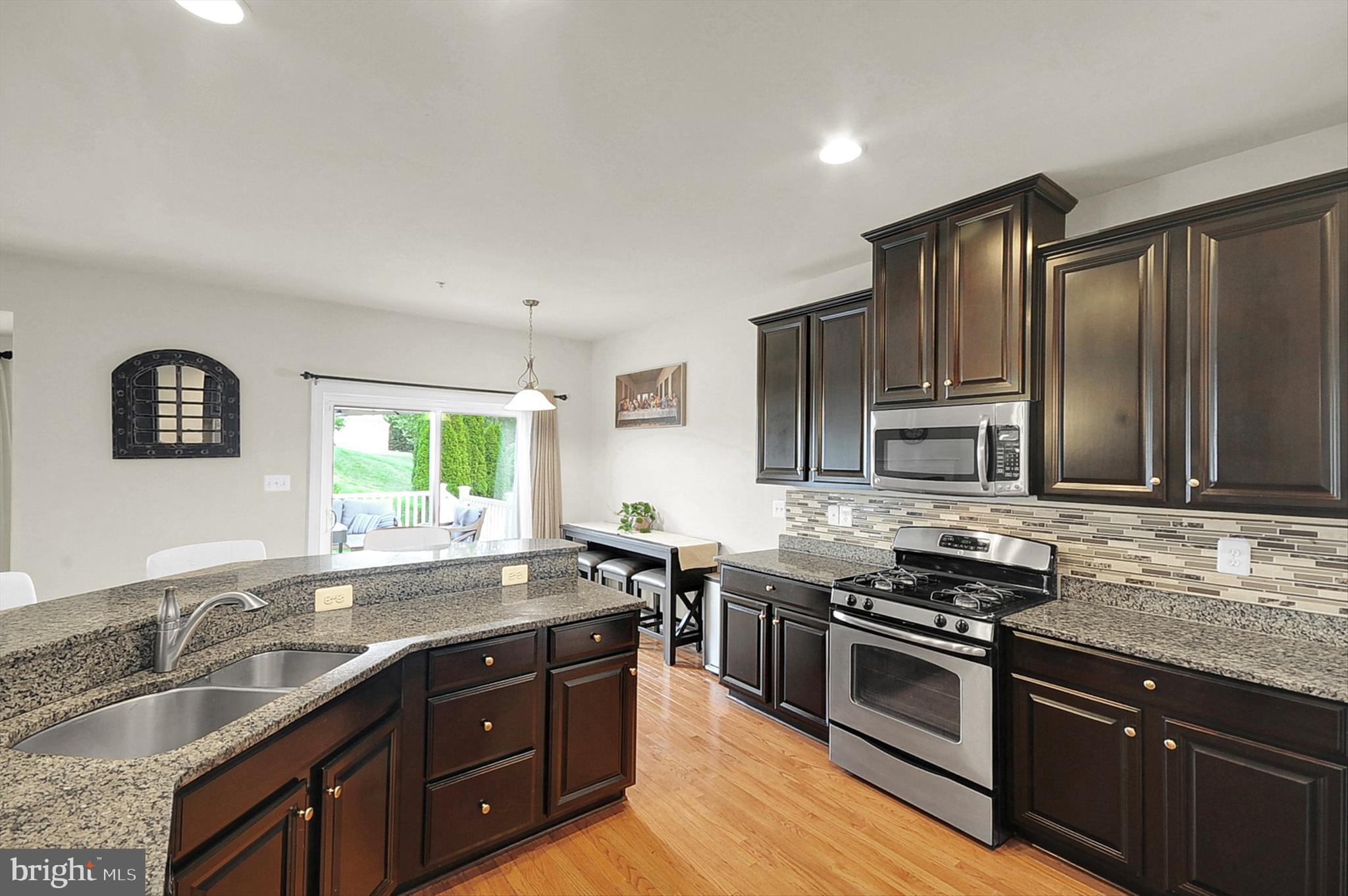 2405 Cindy Lane Warrington, PA 18976 - Photo 14 of 44 a kitchen with stainless steel appliances granite countertop a sink stove and oven
