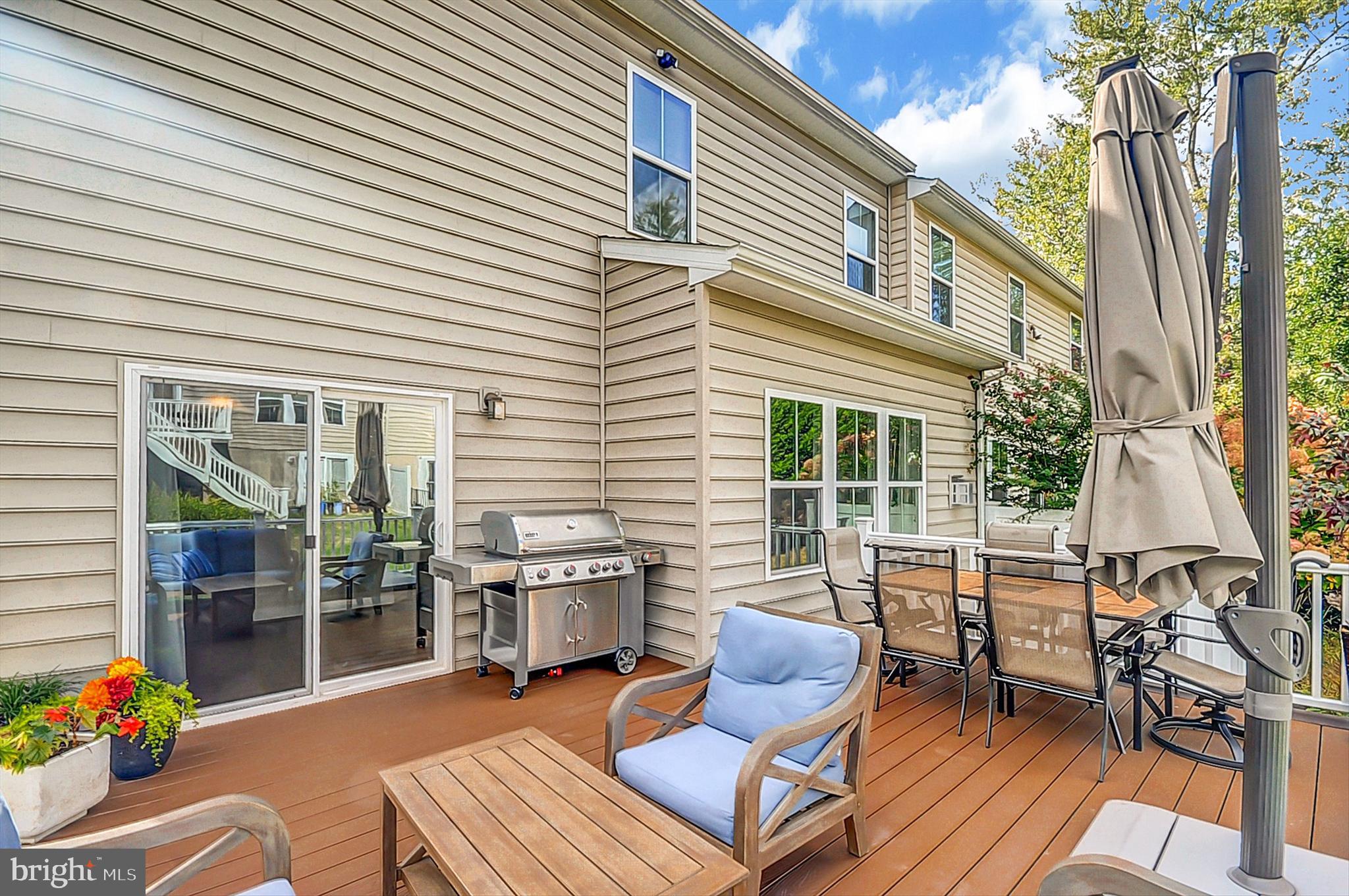 2405 Cindy Lane Warrington, PA 18976 - Photo 16 of 44 a view of a patio with a dining table and chairs with wooden floor and fence