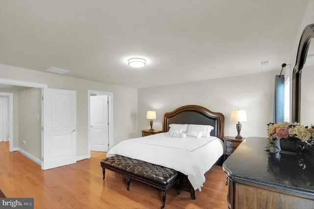 a bedroom with a bed and a potted plant