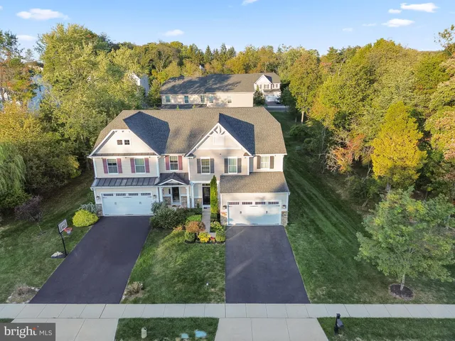 a aerial view of a house next to a yard