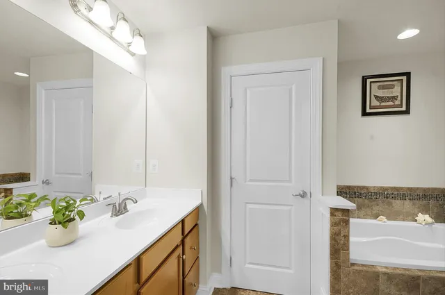 a bathroom with a sink mirror and vanity