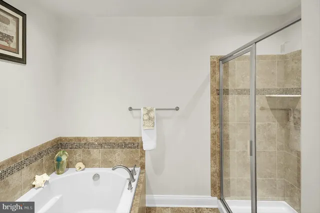 a bathroom with a bathtub and shower