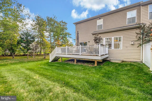 a view of a chair and table in backyard of the house
