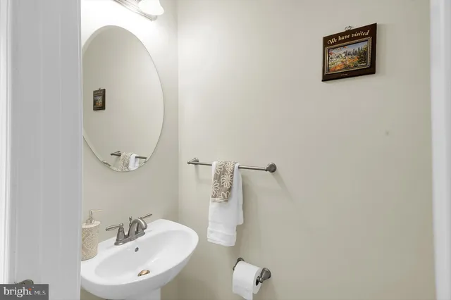 a bathroom with a sink mirror and vanity