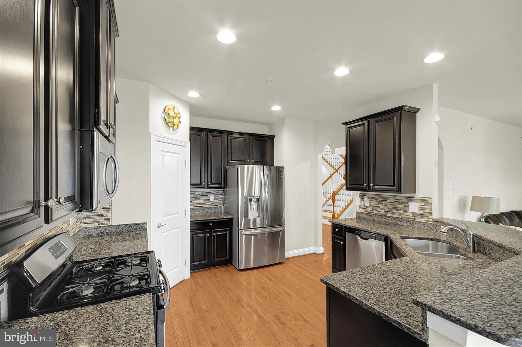 2405 Cindy Lane Warrington, PA 18976 - Photo 10 of 44 a kitchen with kitchen island granite countertop stainless steel appliances a stove a sink and a refrigerator