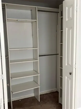 a bedroom with a bed and a chair
