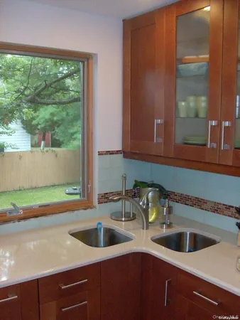 a kitchen with a sink and large window
