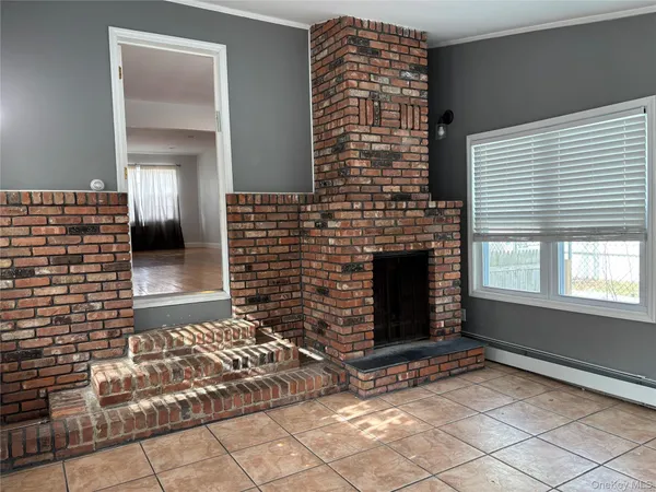 a view of a livingroom with an empty space and window