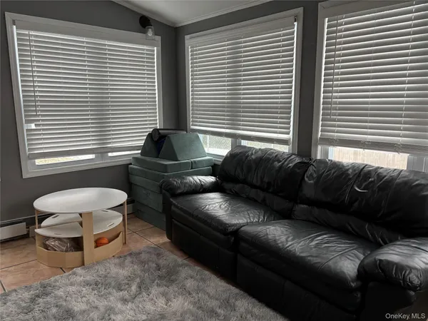 a bedroom with a bed and a flat tv screen on dresser