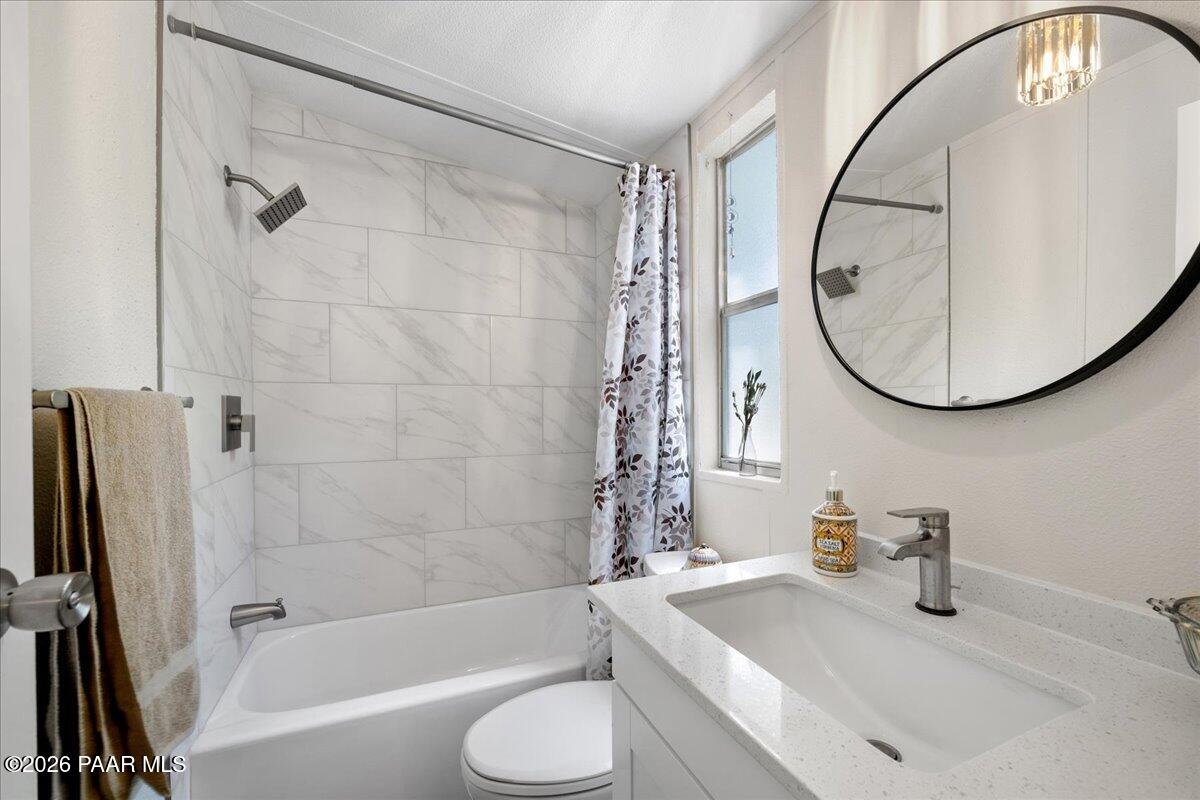 689 Whipple Street, Unit 8 Prescott, AZ 86301 - Photo 15 of 17 a bathroom with a sink a toilet and a mirror