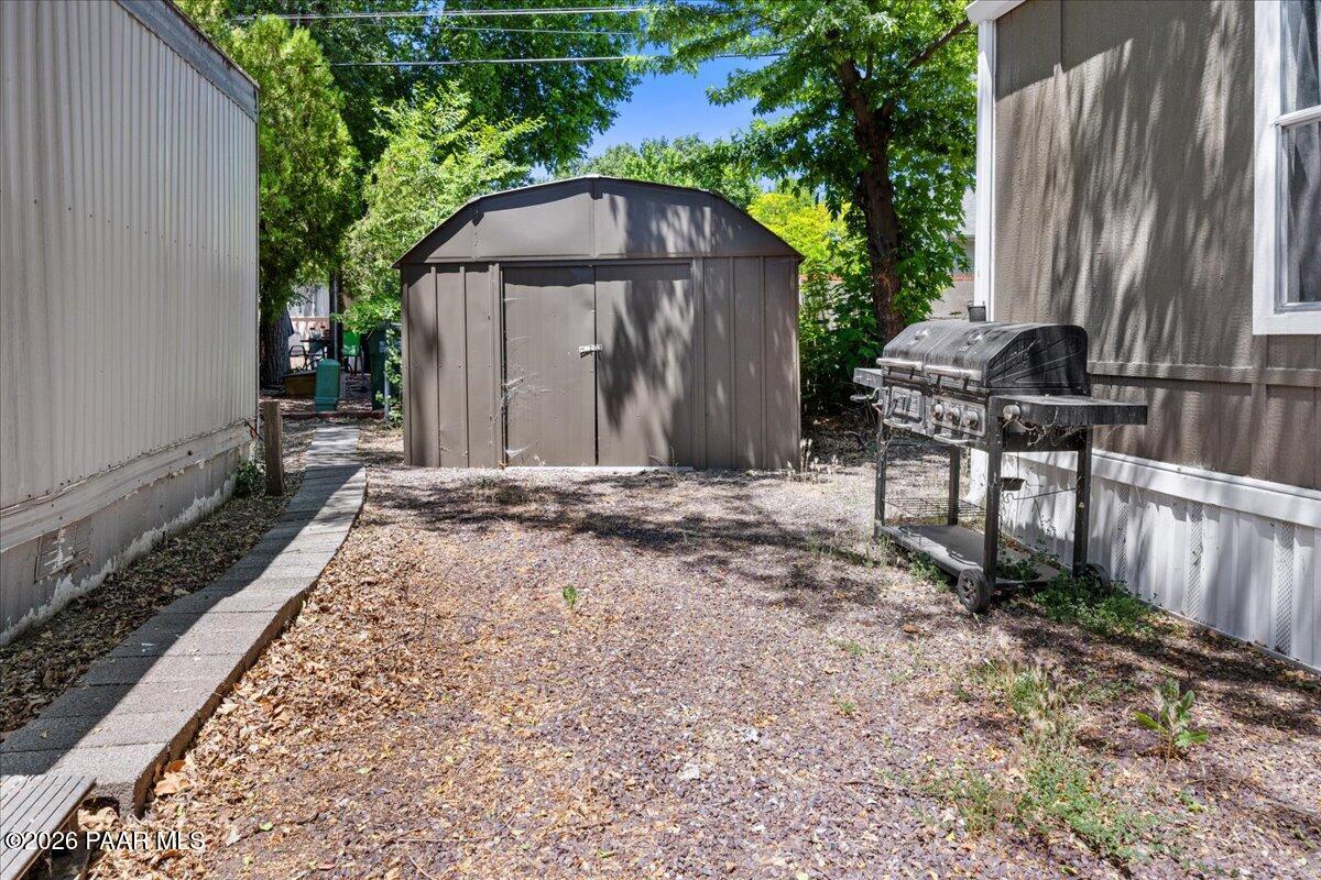 689 Whipple Street, Unit 8 Prescott, AZ 86301 - Photo 17 of 17 a backyard of a house with table and chairs