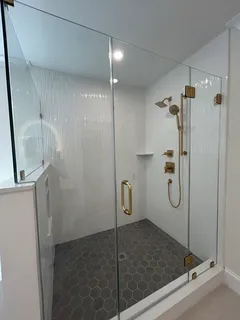 an empty room with wooden floor a ceiling fan and windows