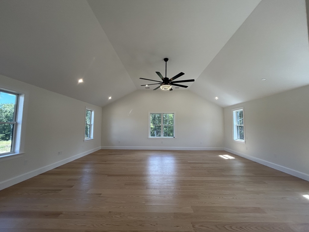 12 Cranberry Mdw Way North Reading, MA 01864 - Photo 18 of 35 an empty room with wooden floor a ceiling fan and windows