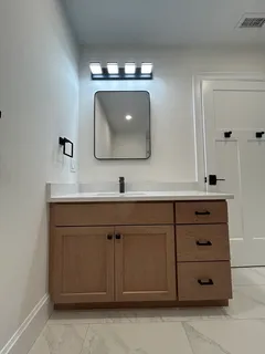 a bathroom with a double vanity sink and a mirror