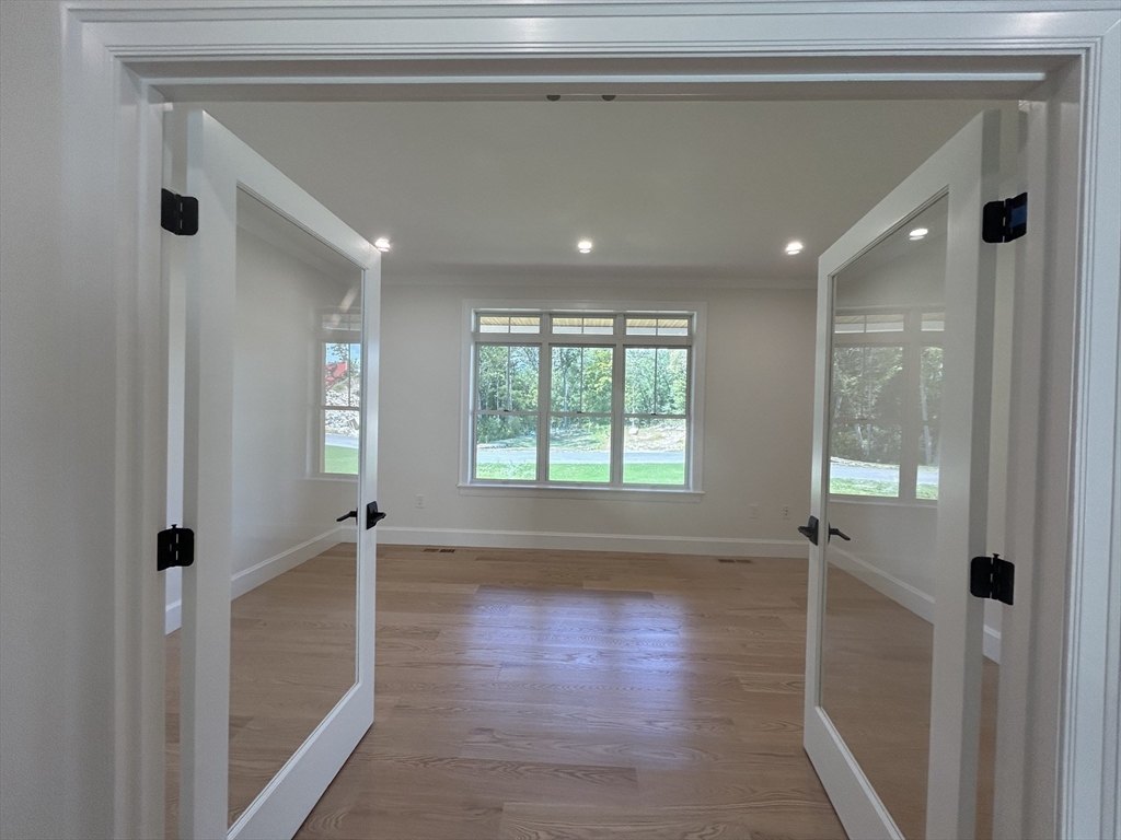 12 Cranberry Mdw Way North Reading, MA 01864 - Photo 28 of 35 a view of empty room with wooden floor and fan