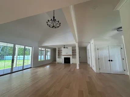 a kitchen with a stove and wooden floor