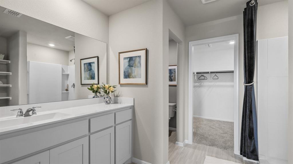 557 Marsh Street Cleburne, TX 76033 - Photo 17 of 40 a bathroom with a double vanity sink mirror and shower