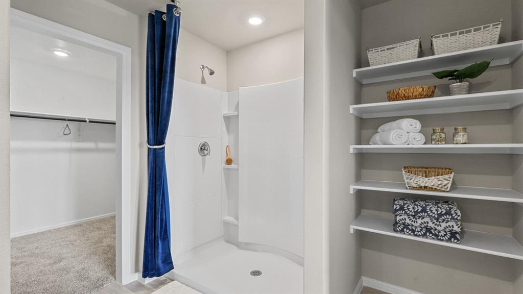 557 Marsh Street Cleburne, TX 76033 - Photo 18 of 40 a bathroom with a bathtub and a shower
