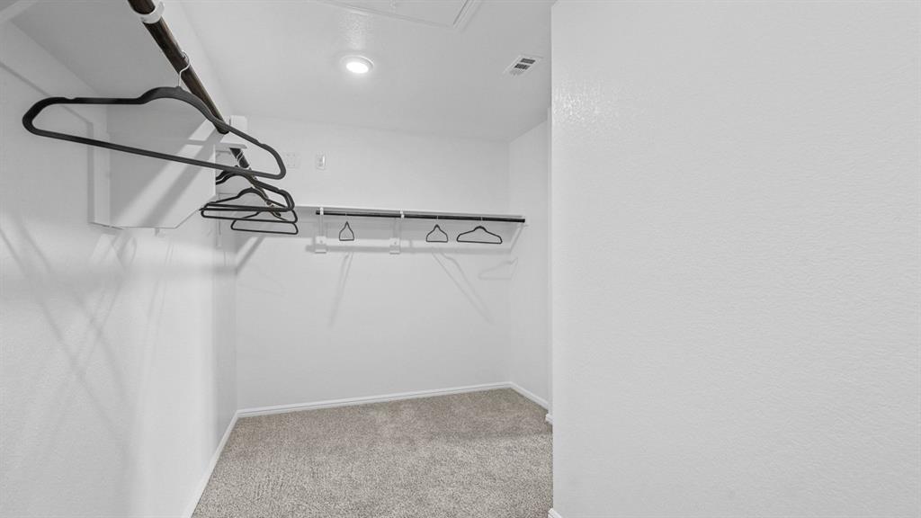 557 Marsh Street Cleburne, TX 76033 - Photo 22 of 40 a view of a room with racks on the wall