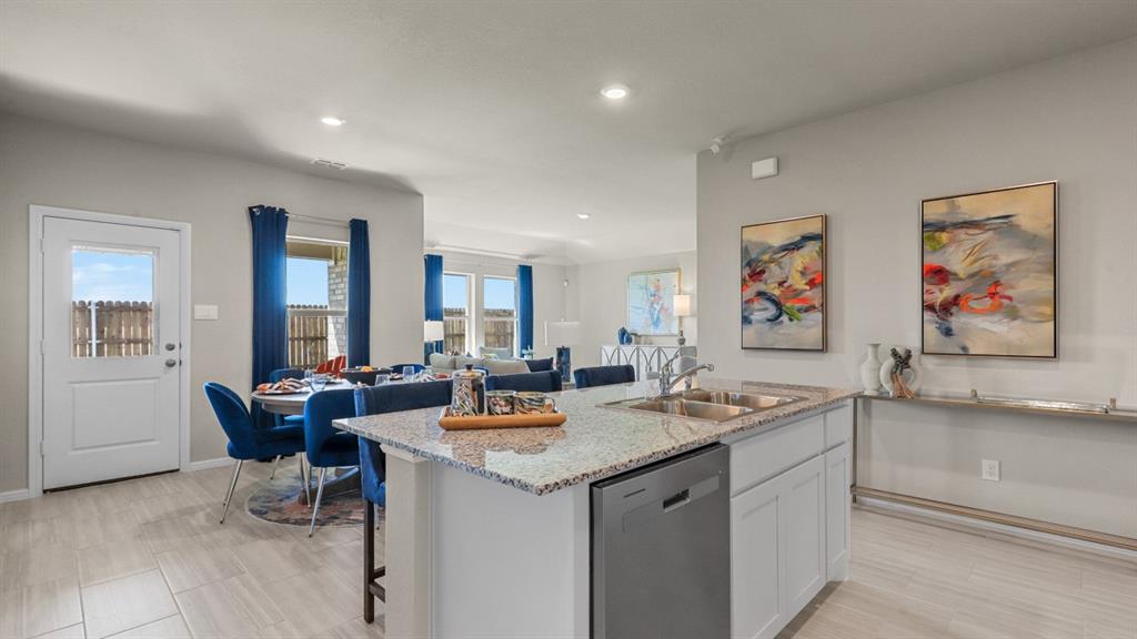 557 Marsh Street Cleburne, TX 76033 - Photo 2 of 40 a view of a kitchen area with furniture and wooden floor