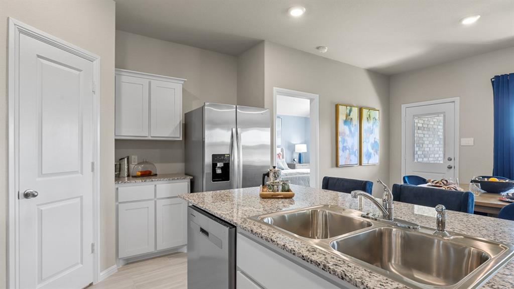 557 Marsh Street Cleburne, TX 76033 - Photo 4 of 40 a kitchen with a sink stove and cabinets