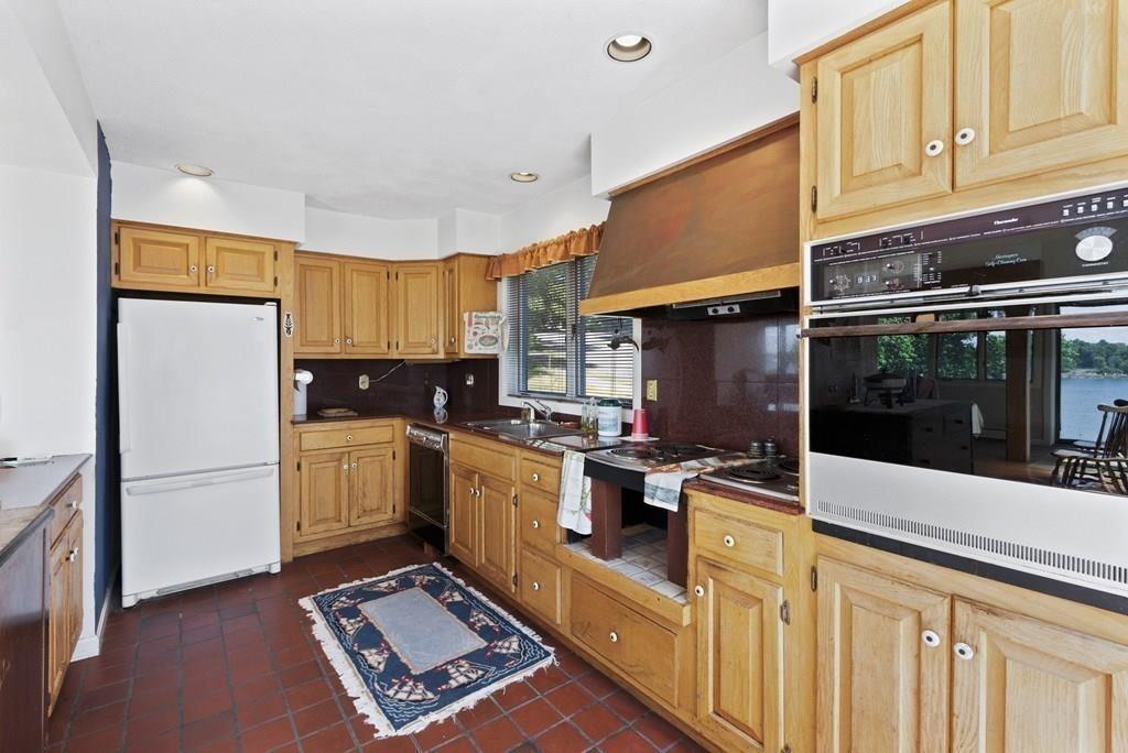 50 Pinecliff Drive Marblehead, MA 01945 - Photo 16 of 41 a kitchen with refrigerator and cabinets