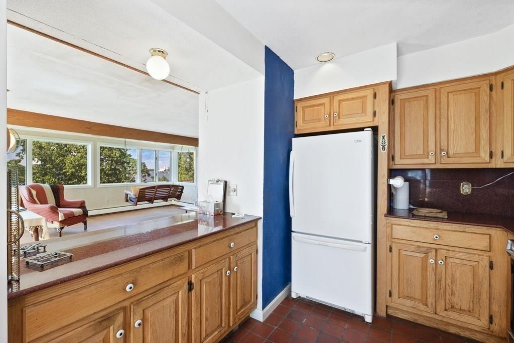 50 Pinecliff Drive Marblehead, MA 01945 - Photo 17 of 41 a kitchen with white cabinets and white appliances