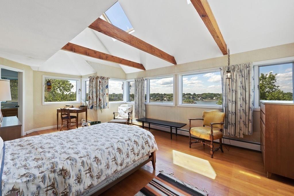 50 Pinecliff Drive Marblehead, MA 01945 - Photo 26 of 41 a bedroom with a bed a table and large windows