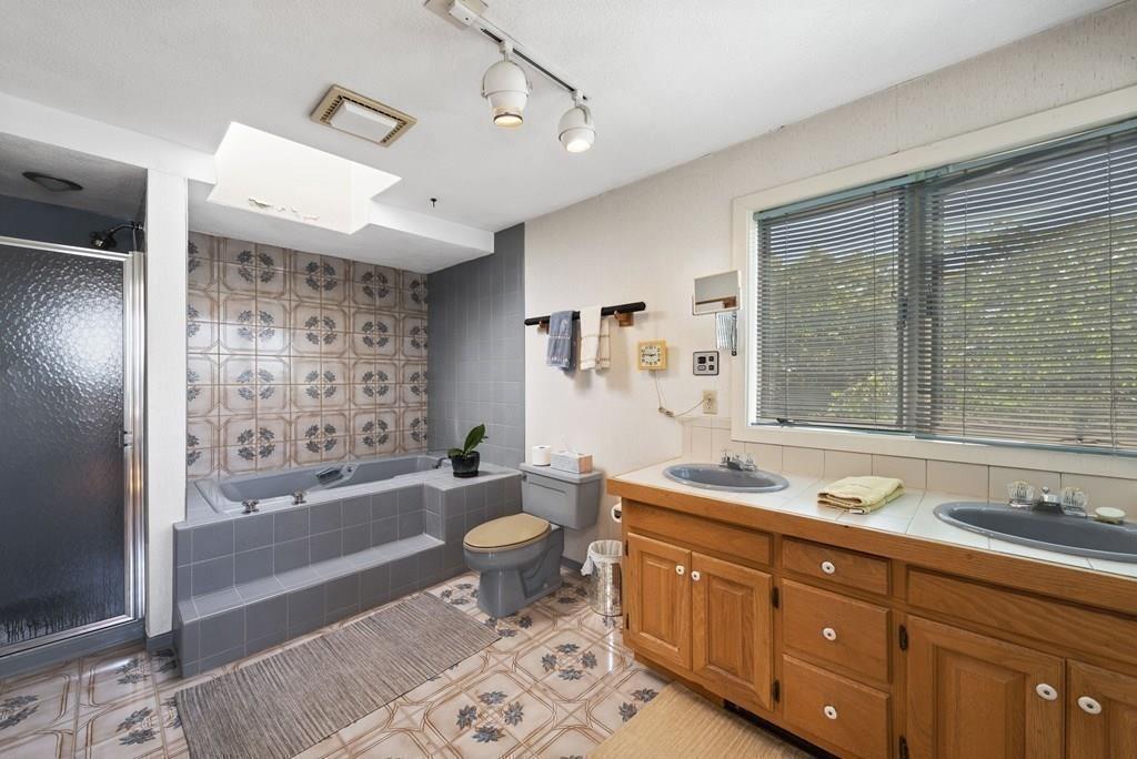 50 Pinecliff Drive Marblehead, MA 01945 - Photo 29 of 41 a bathroom with a granite countertop double vanity sink a toilet a mirror and bathtub