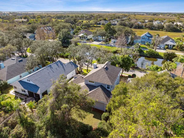 an aerial view of a house with a mountain