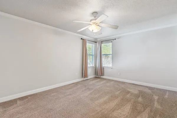 a view of an empty room with a ceiling fan