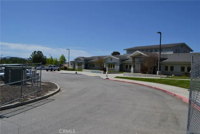 a view of a yard with wooden fence
