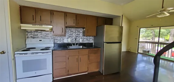 a kitchen with a refrigerator stove and sink